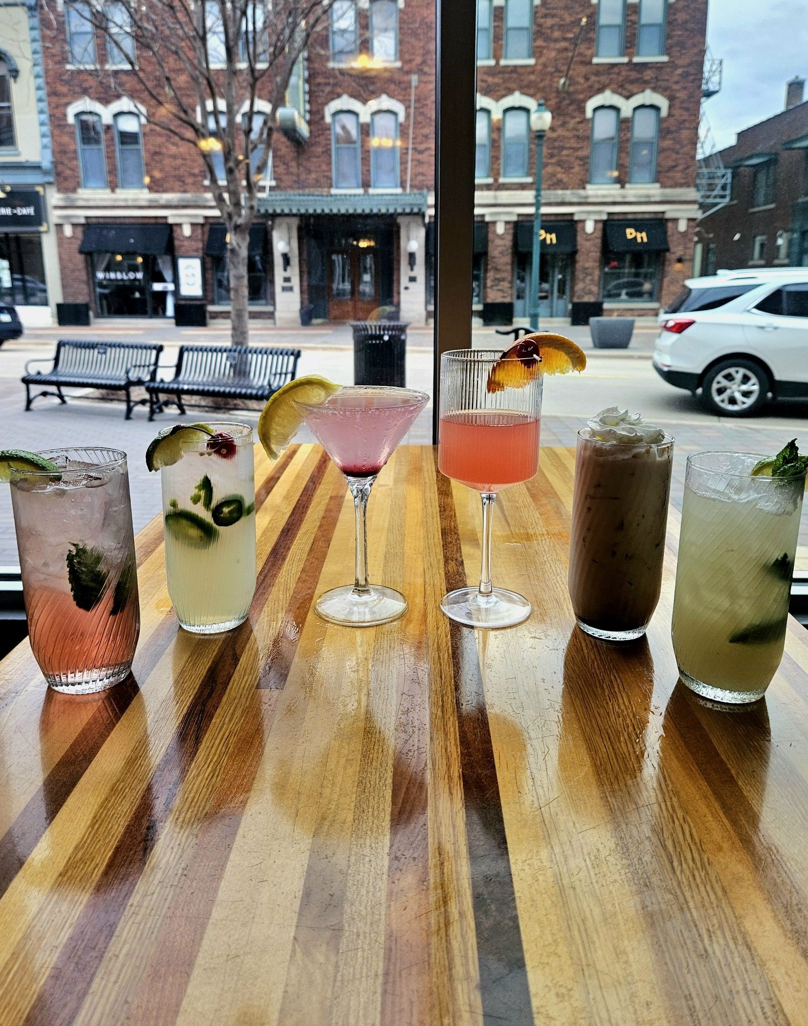 Craft cocktails and drinks at Wilbo Burgers bar with a view of Main Street Cedar Falls