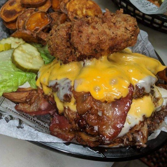 The Piggy Back Burger — pork patty with house-smoked pulled pork and slaw