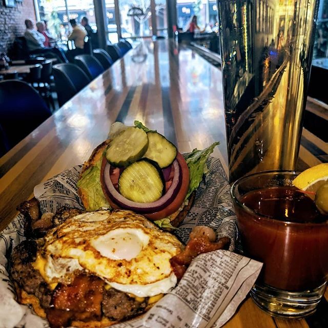 A stacked Wilbo burger piled with bacon, cheese, jalape&ntilde;os and pickles &mdash; handcrafted in Cedar Falls